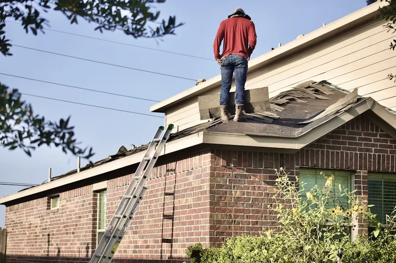 Professional roofer working on a residential roof in Pine Tree Corners